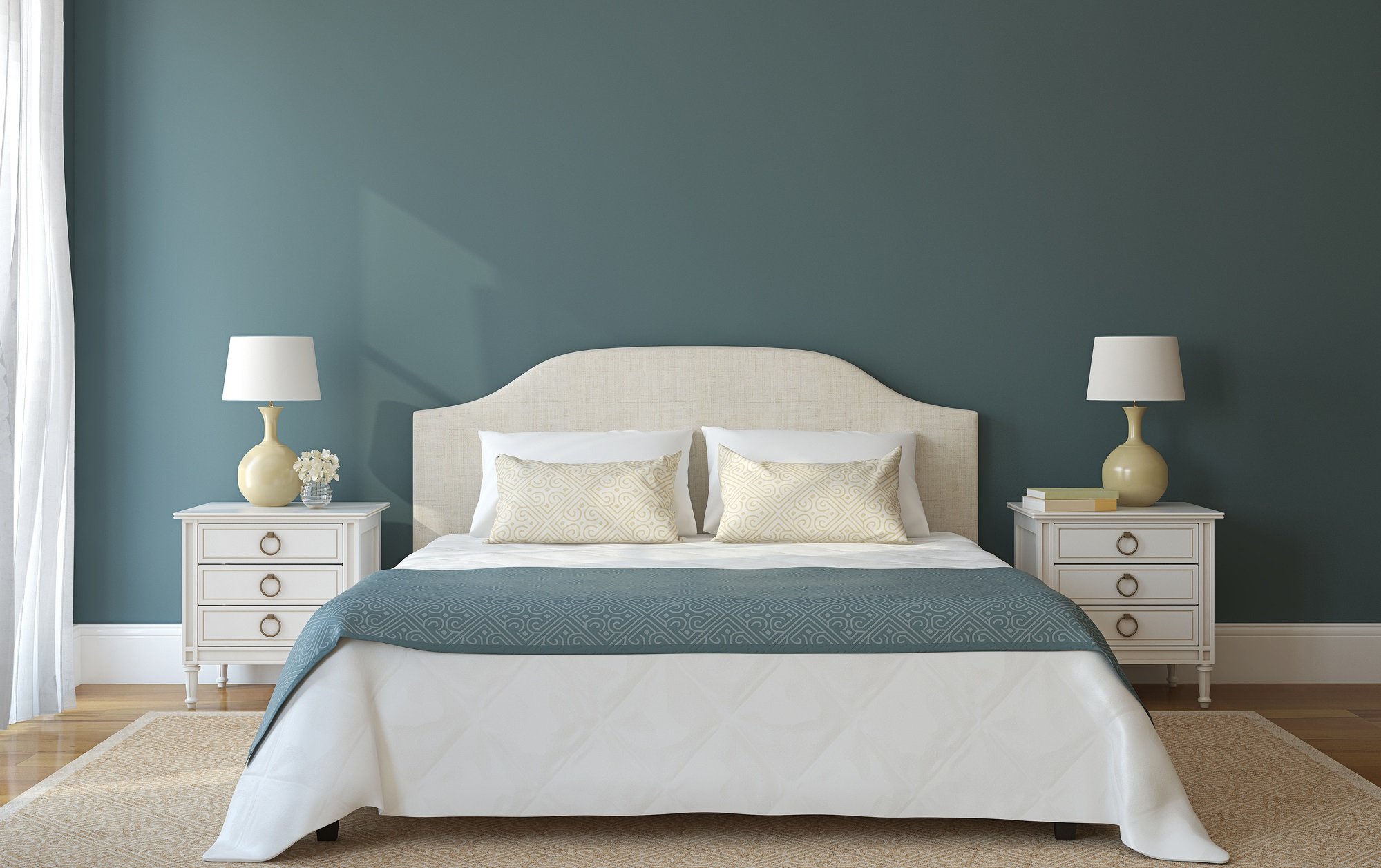 A bedroom with blue-sage-colored walls